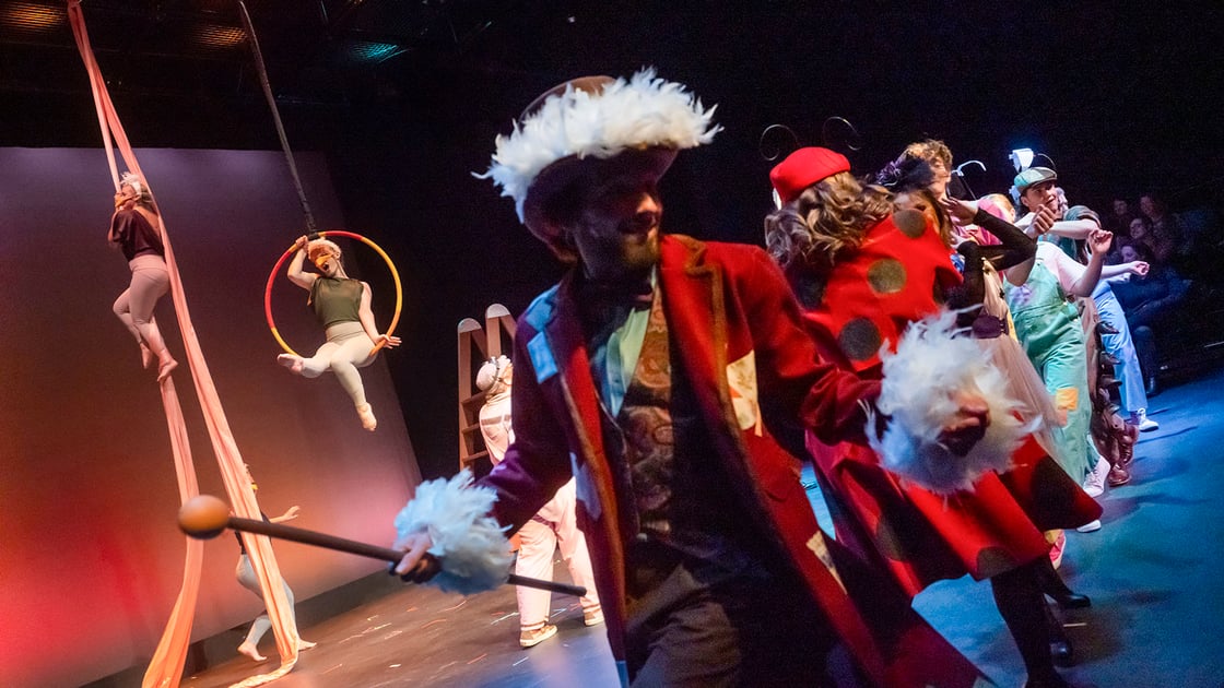 a group of students dressed in theatrical costumes form a line on a brightly lit stage during ETSU’s production of James and the Giant Peach