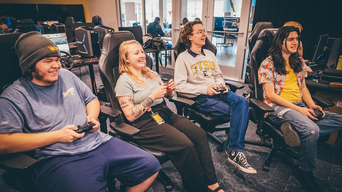 ETSU Esports students laughing and playing a video game
