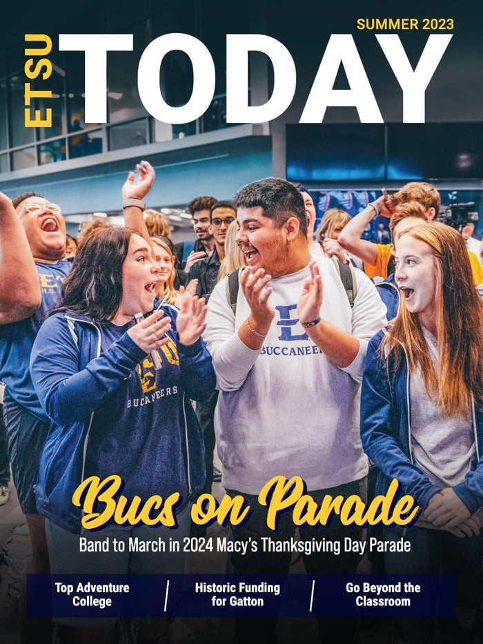 The cover of ETSU Today features several members of the ETSU Marching Bucs celebrating. The headline reads “Bucs on Parade: Band to March in 2024 Macy’s Thanksgiving Day Parade.”