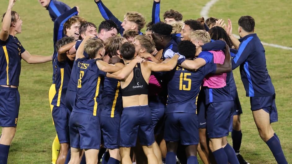 ETSU’s men’s soccer team huddles in joyous celebration